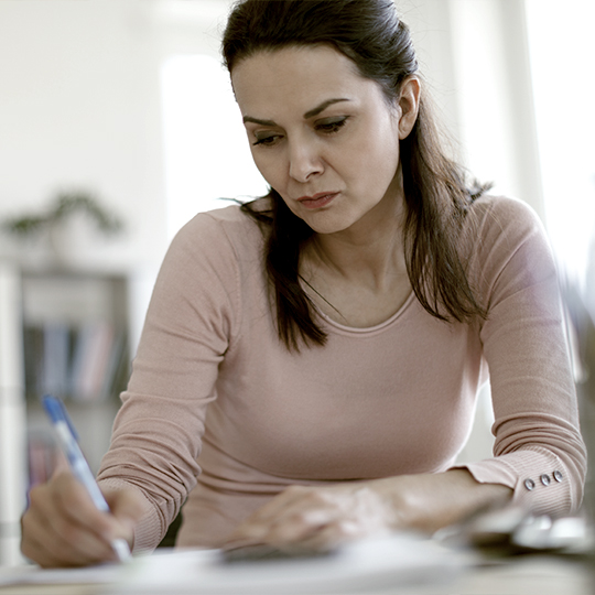 Woman writing at desk