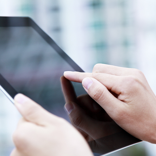 Hand pointing on a tablet.