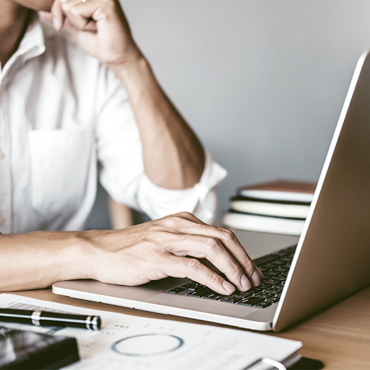 hand on laptop keyboard