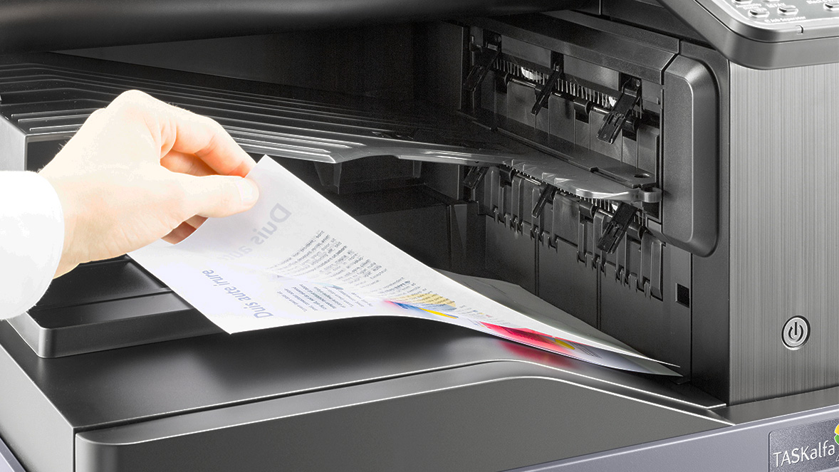 hand retrieving items from a printer