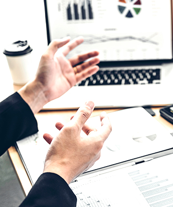 hands with papers and laptop