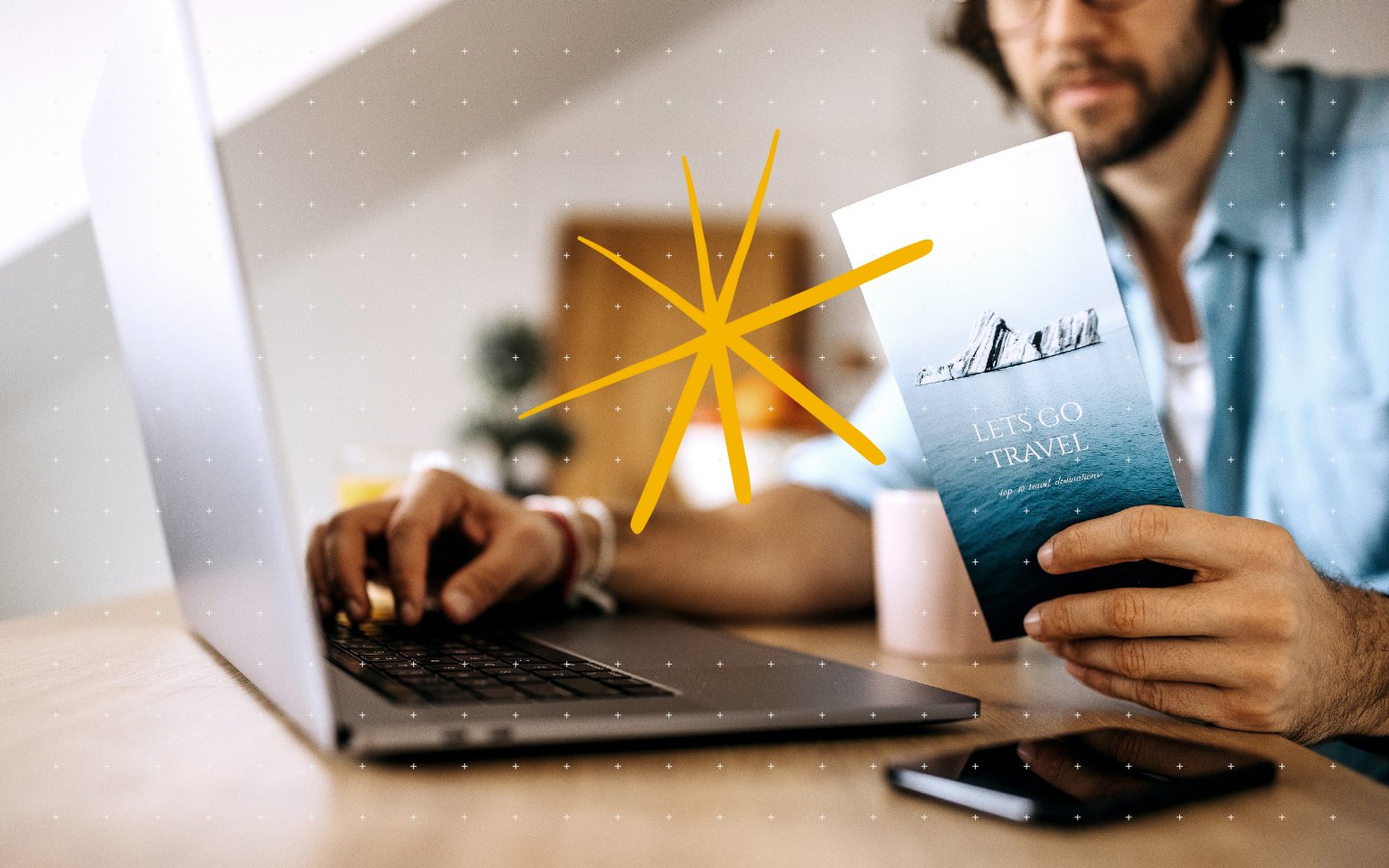 man with laptop and brochure