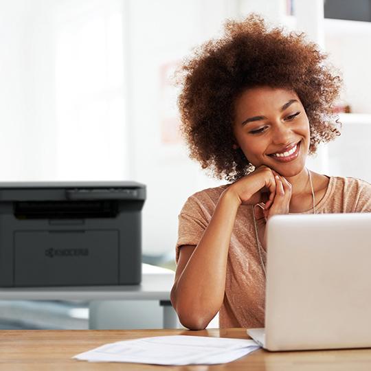 The wait is over - check out the devices! woman smiling with laptop and printer