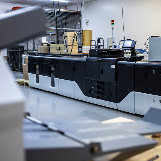 More uptime, less maintenance with Kyocera. Inkjet printer at a commercial printshop.