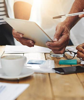 Our values keep us focused on what matters close up of colleagues working on a tablet