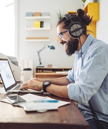 man smiling looking at laptop