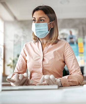 Woman with mask typing